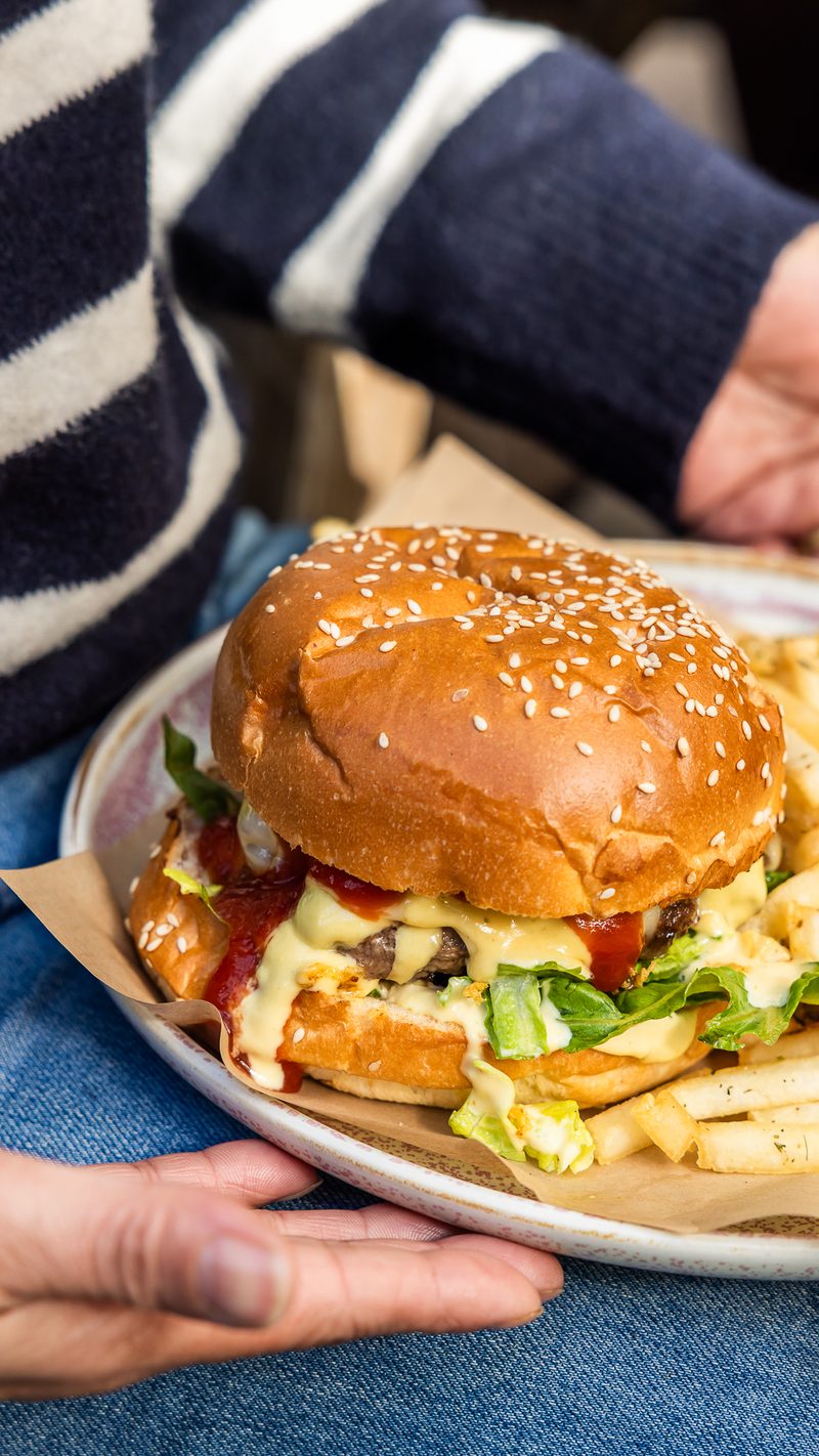 Bacon and egg burger held in hand