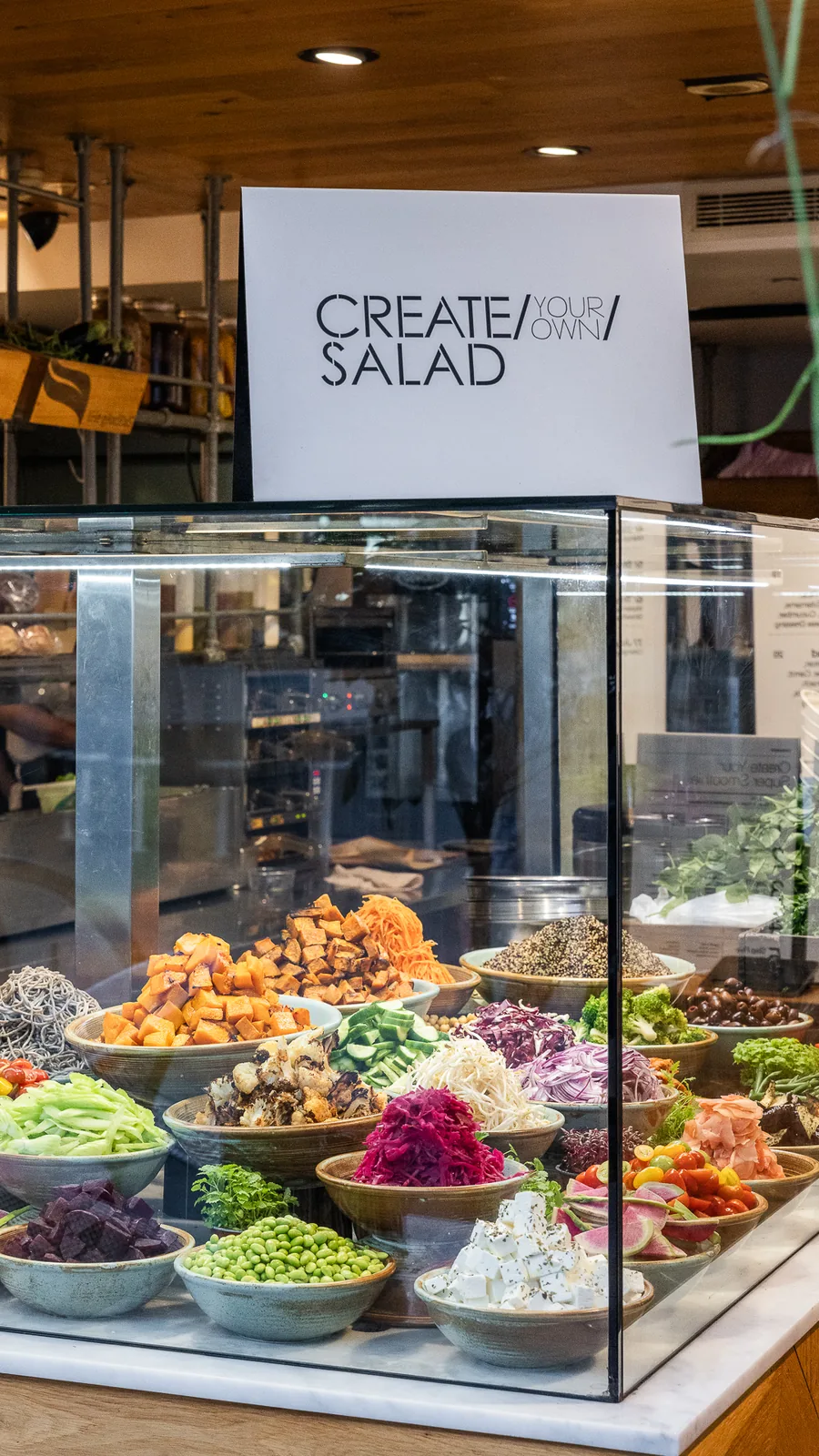 The Gardens 259 create-your-own salad bar, bowls of fresh ingredients under glass